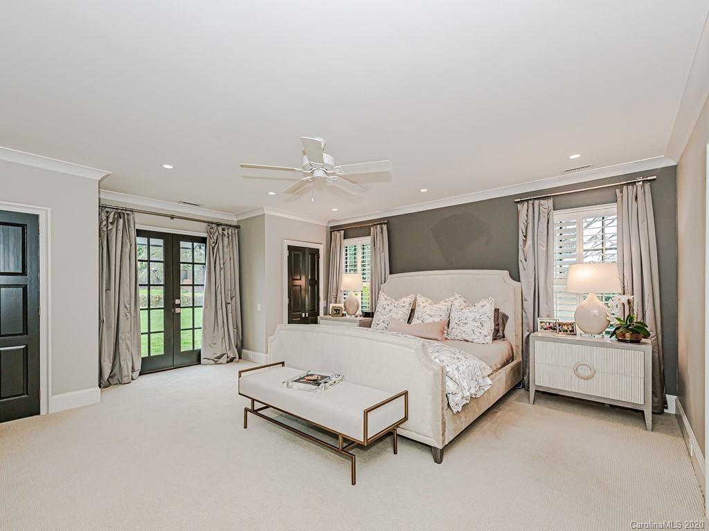 3429 Sharon Road Charlotte, NC 28211 - Photo 25 of 48 a bedroom with a large bed and a large window