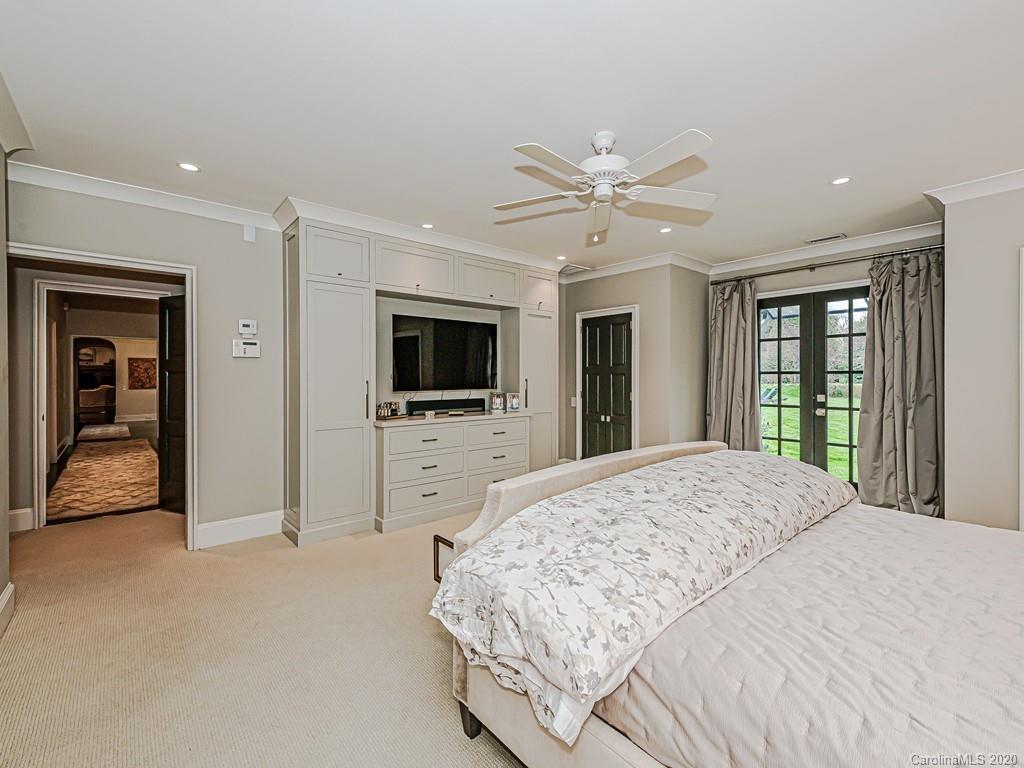 3429 Sharon Road Charlotte, NC 28211 - Photo 27 of 48 a spacious bedroom with a large bed and a flat screen tv