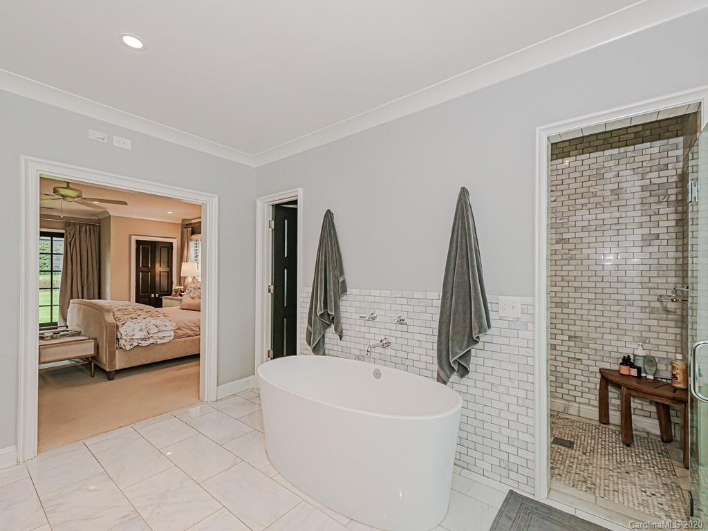 3429 Sharon Road Charlotte, NC 28211 - Photo 29 of 48 a bathroom with a tub sink and a window