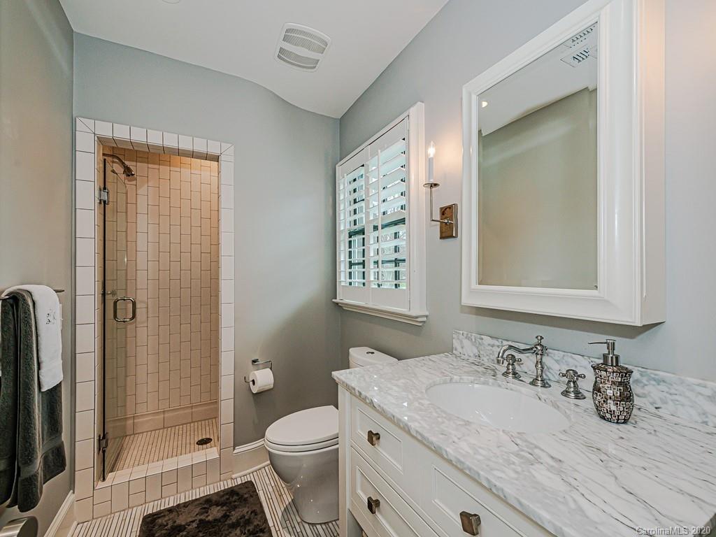 3429 Sharon Road Charlotte, NC 28211 - Photo 34 of 48 a bathroom with a granite countertop sink toilet and shower