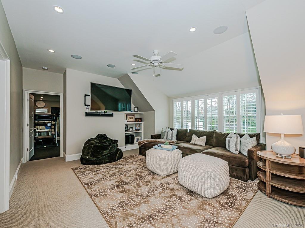 3429 Sharon Road Charlotte, NC 28211 - Photo 35 of 48 a living room with furniture a flat screen tv and a large window
