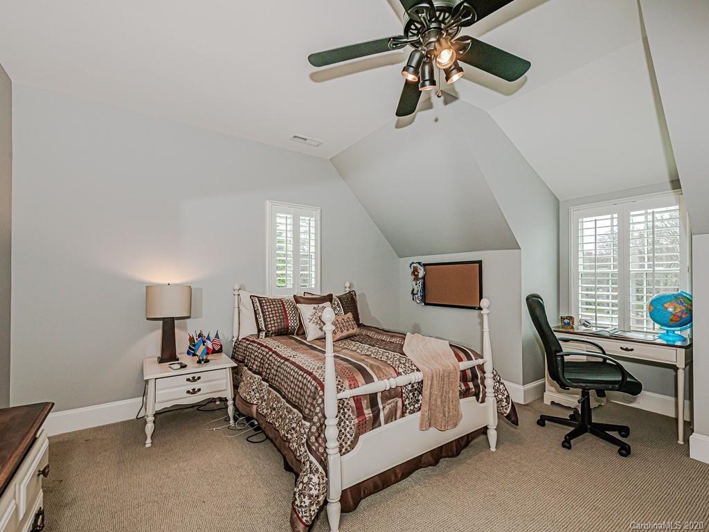 3429 Sharon Road Charlotte, NC 28211 - Photo 41 of 48 a bedroom with a bed a couch and a window