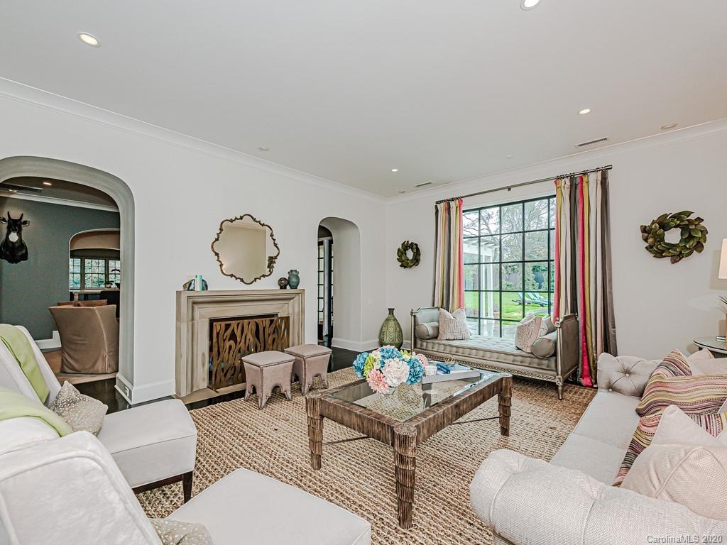 3429 Sharon Road Charlotte, NC 28211 - Photo 6 of 48 a living room with furniture a fireplace and a floor to ceiling window