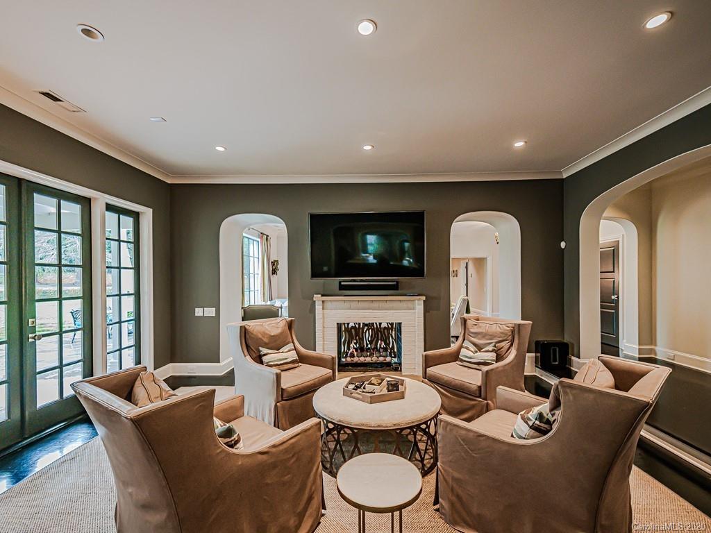3429 Sharon Road Charlotte, NC 28211 - Photo 10 of 48 a living room with fireplace furniture and a flat screen tv