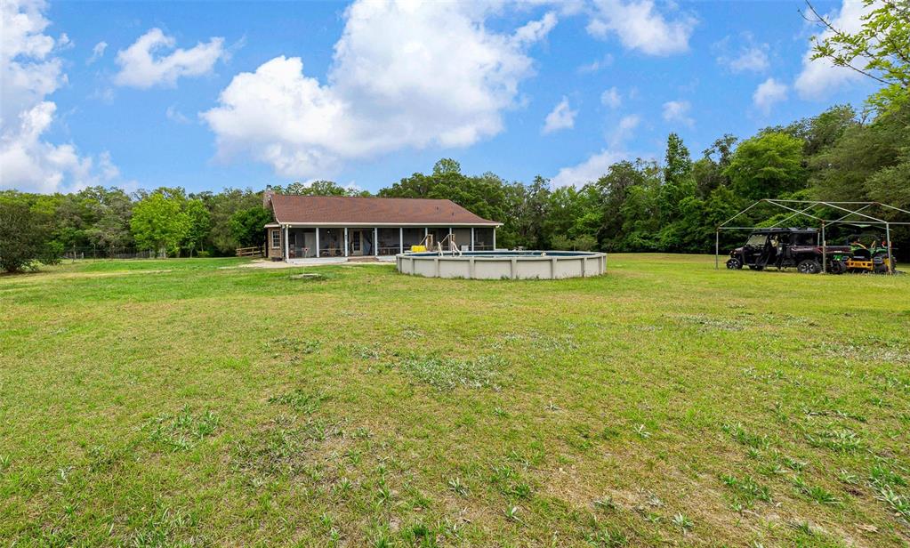 732 Carl Wilson Road Fort White, FL 32038 - Photo 55 of 80 a view of a large pool with an outdoor space and seating area