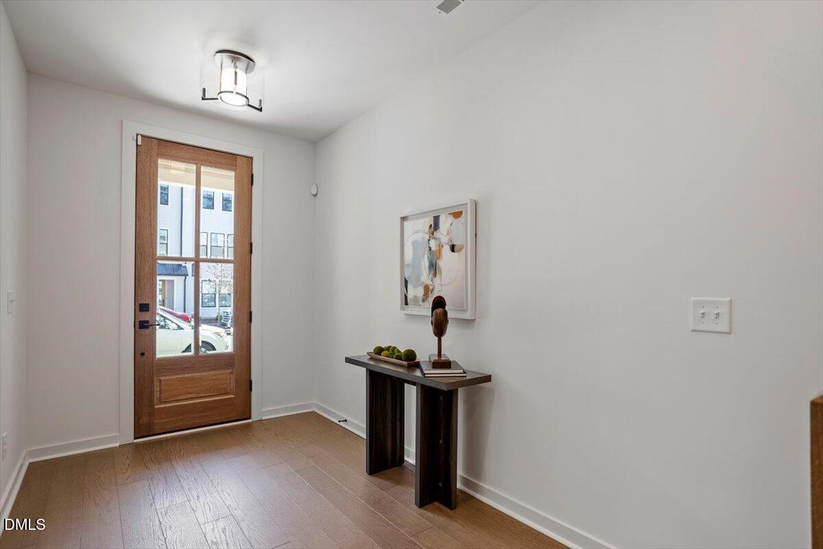 6419 Tanner Oak Lane Raleigh, NC 27613 - Photo 5 of 39 a view of a livingroom with a window and wooden floor