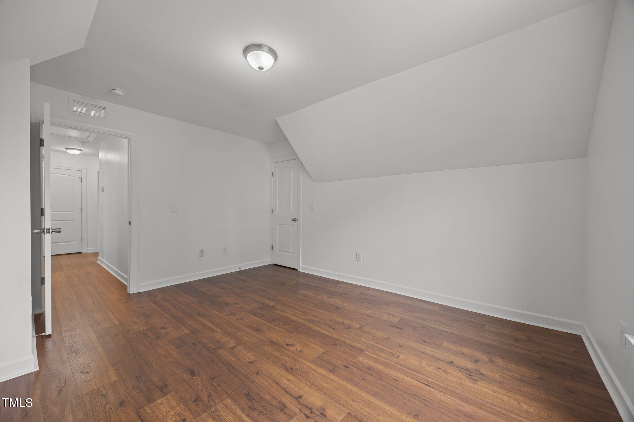 88 Arbor Loop Angier, NC 27501 - Photo 14 of 36 a view of an empty room with wooden floor and a window