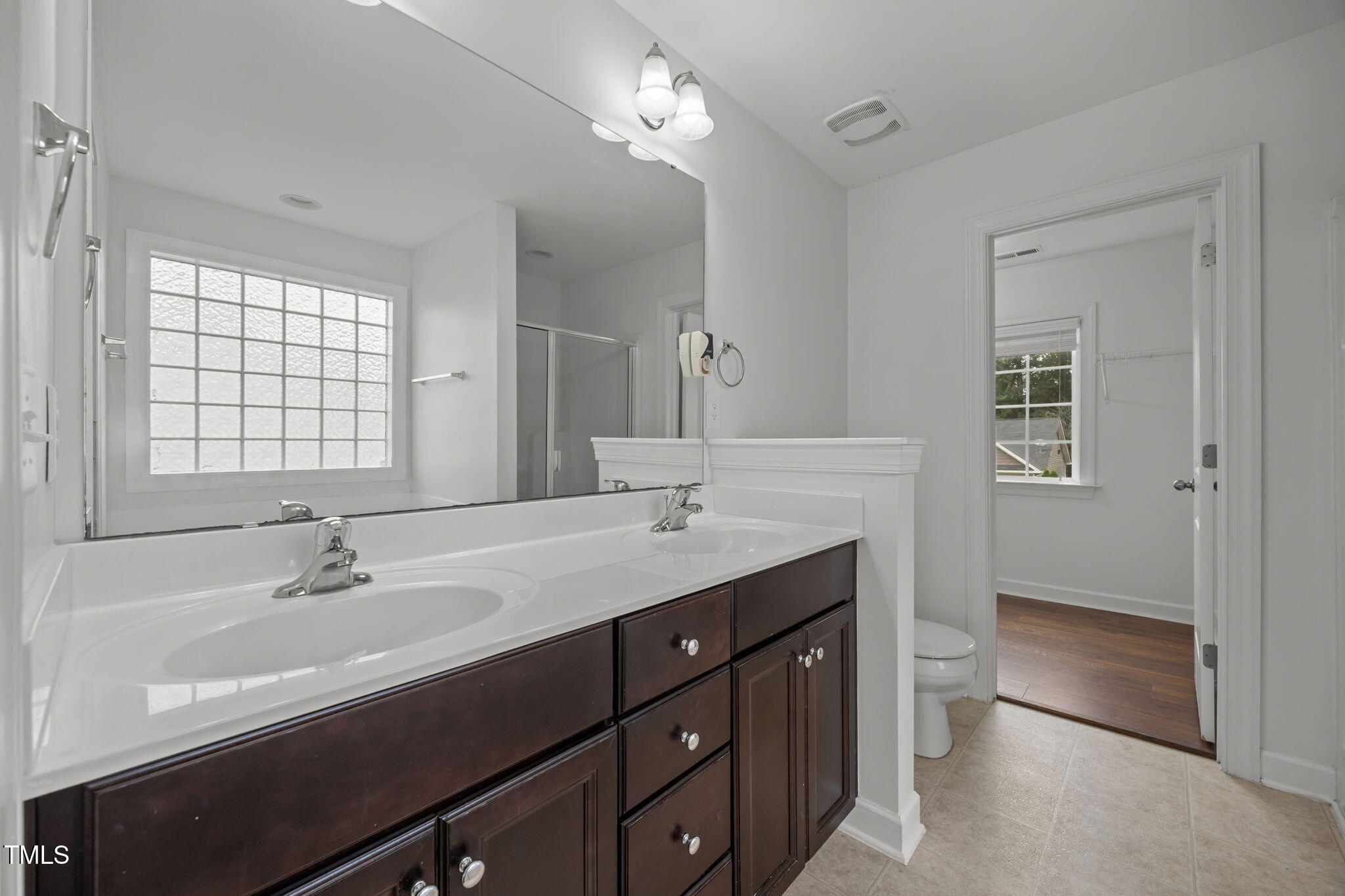 88 Arbor Loop Angier, NC 27501 - Photo 16 of 36 a bathroom with a double vanity sink a mirror and a bathtub