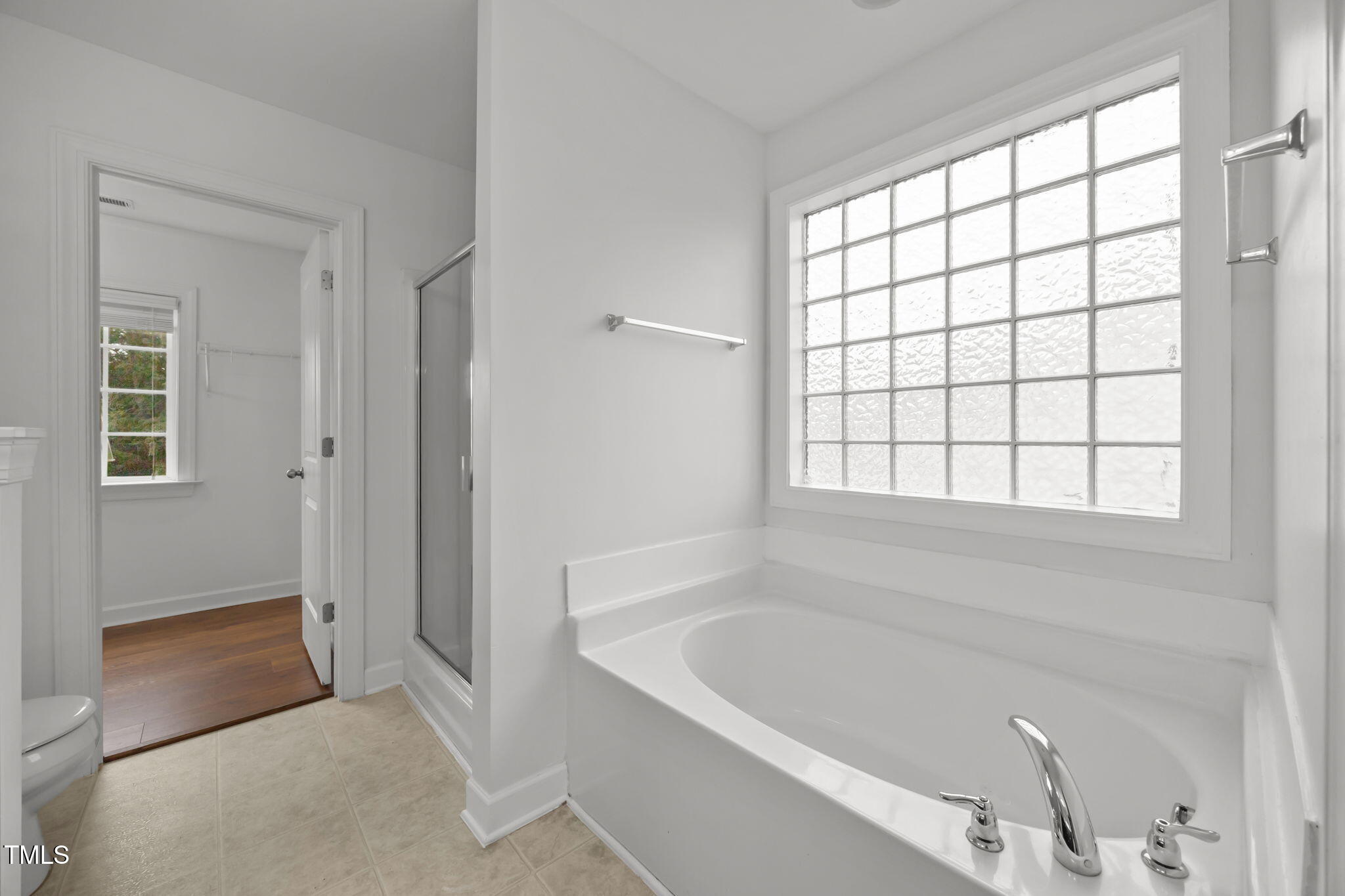 88 Arbor Loop Angier, NC 27501 - Photo 20 of 36 a bathroom with a bathtub and next to a window