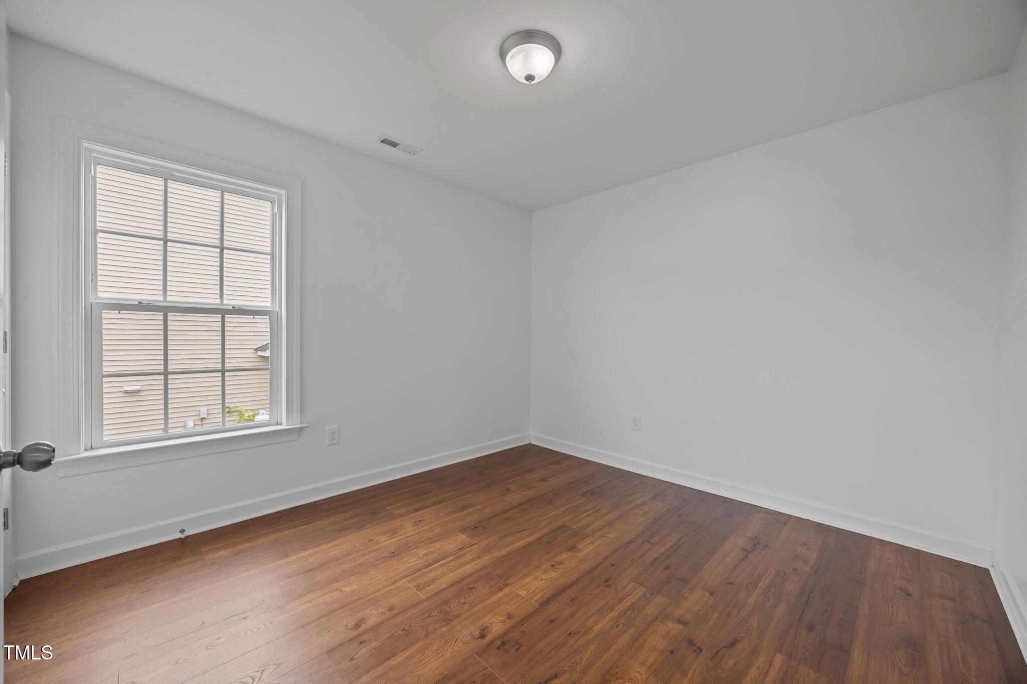 88 Arbor Loop Angier, NC 27501 - Photo 22 of 36 an empty room with wooden floor and windows