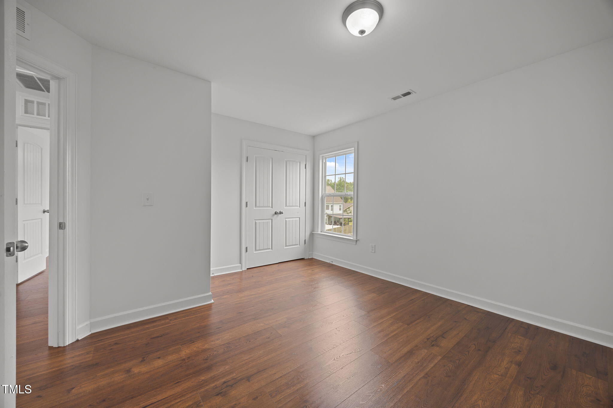 88 Arbor Loop Angier, NC 27501 - Photo 25 of 36 an empty room with wooden floor and windows