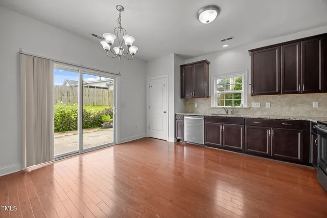 a kitchen with stainless steel appliances granite countertop a stove sink and cabinets