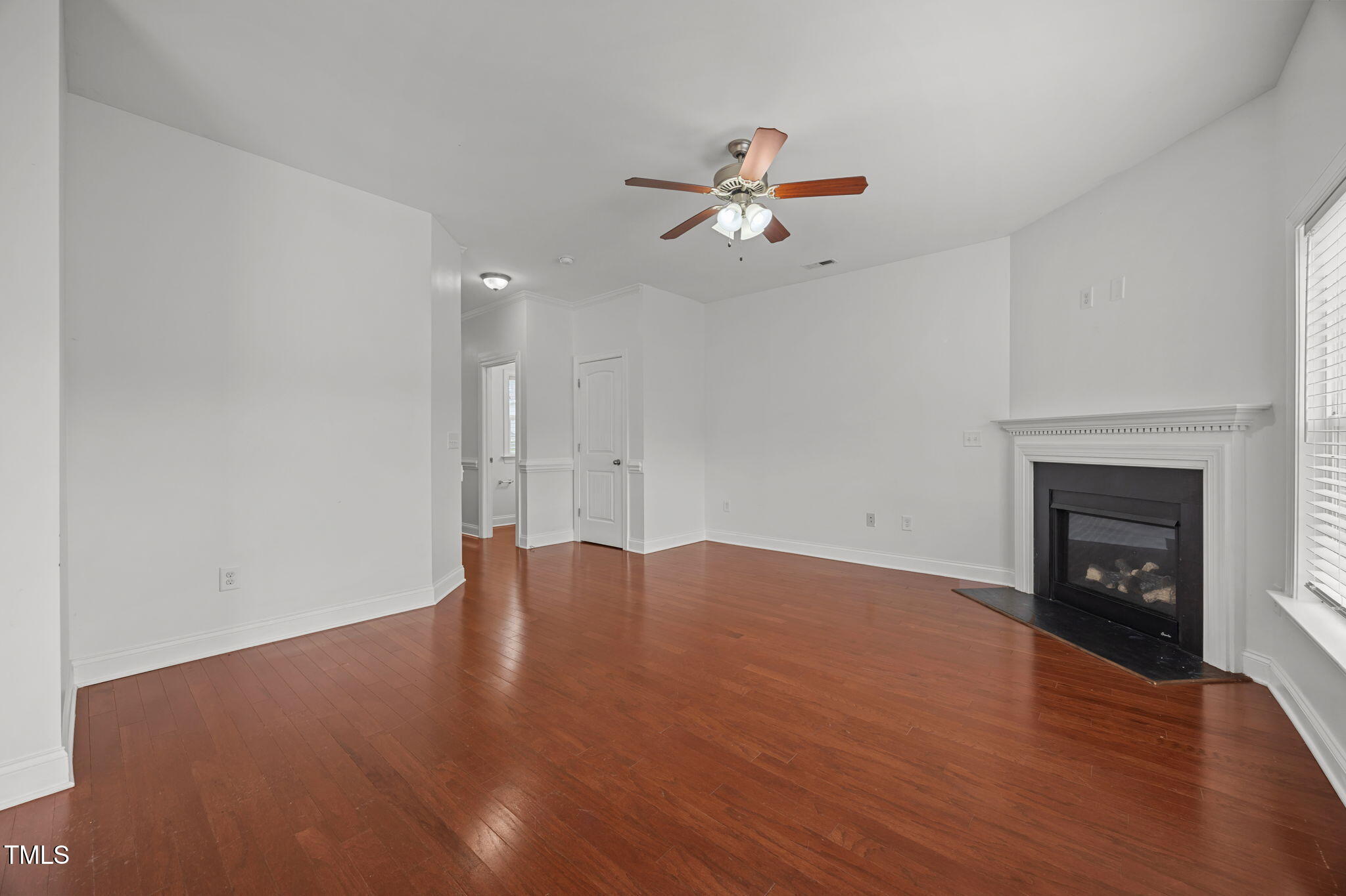 88 Arbor Loop Angier, NC 27501 - Photo 9 of 36 a view of empty room with wooden floor and fireplace
