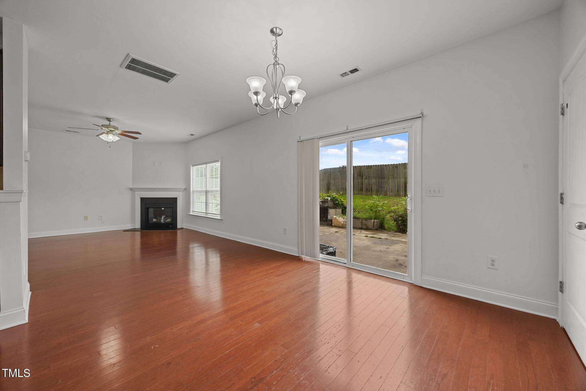88 Arbor Loop Angier, NC 27501 - Photo 10 of 36 a view of a livingroom with wooden floor fireplace and windows