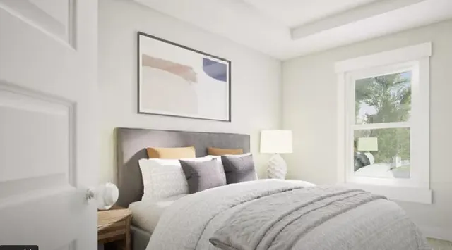 a bedroom with a bed and a painting on the wall