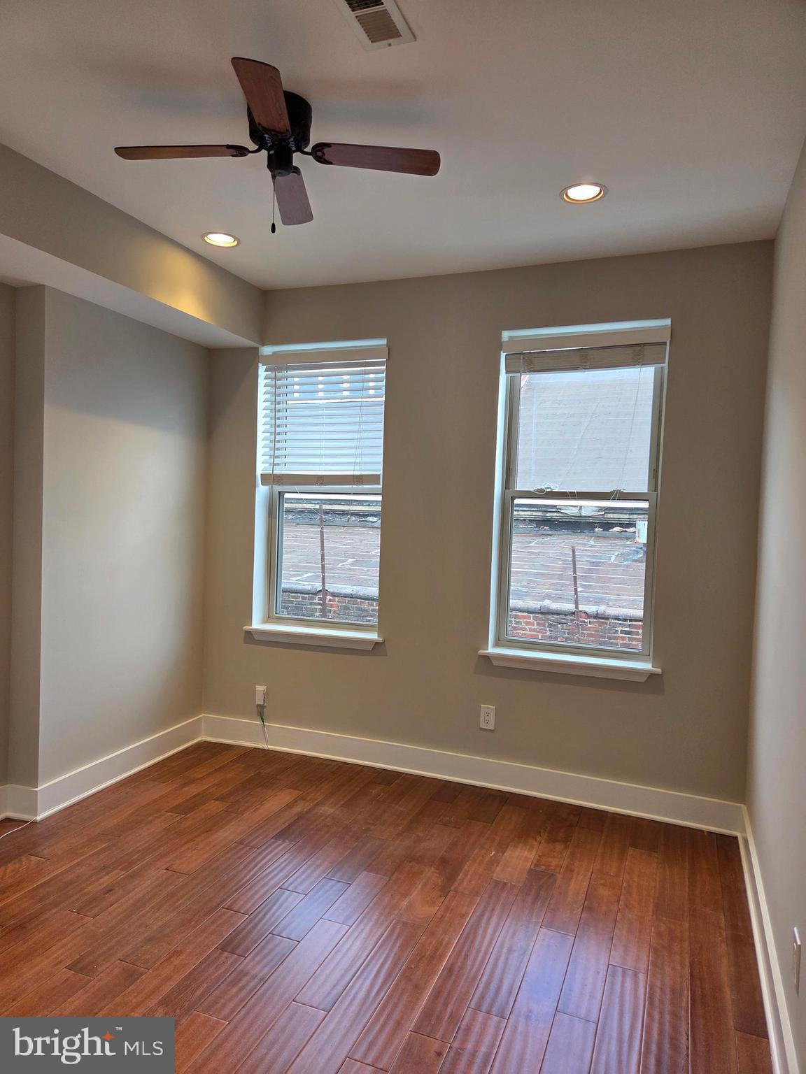 1603 Ellsworth Street, Unit B Philadelphia, PA 19146 - Photo 12 of 43 a view of an empty room with wooden floor and a window