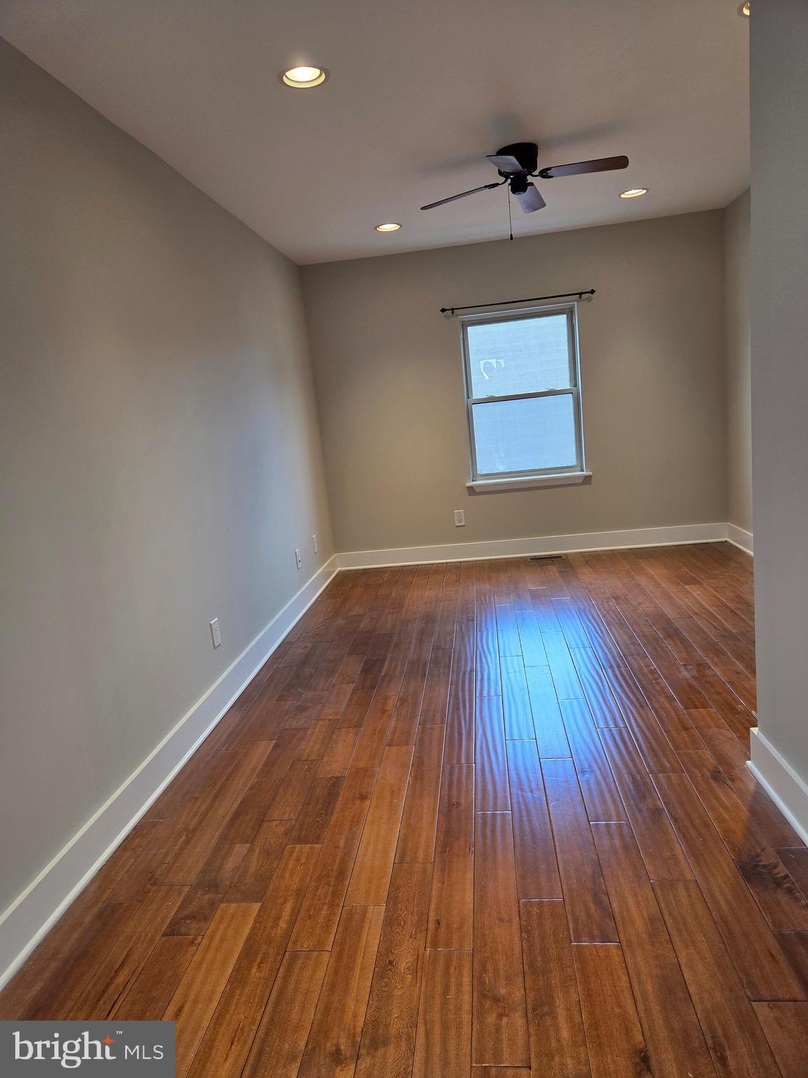 1603 Ellsworth Street, Unit B Philadelphia, PA 19146 - Photo 23 of 43 a view of an empty room with wooden floor and a window
