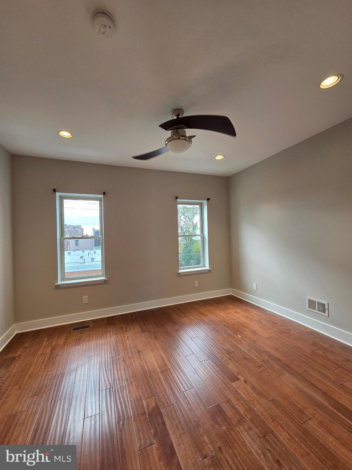 1603 Ellsworth Street, Unit B Philadelphia, PA 19146 - Photo 29 of 43 an empty room with wooden floor and windows