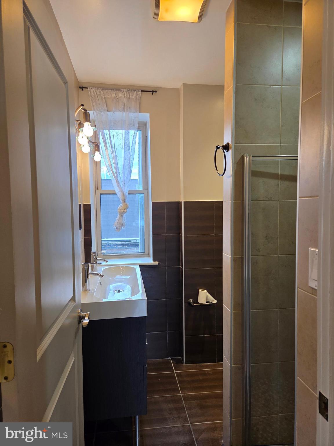 1603 Ellsworth Street, Unit B Philadelphia, PA 19146 - Photo 33 of 43 a bathroom with a sink and a mirror