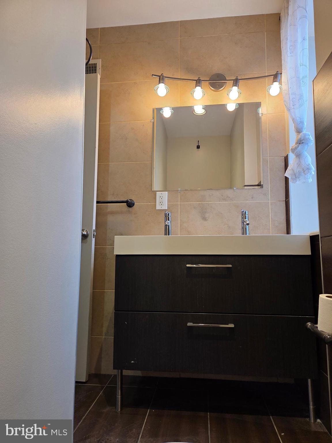 1603 Ellsworth Street, Unit B Philadelphia, PA 19146 - Photo 36 of 43 a bathroom with a sink and a mirror