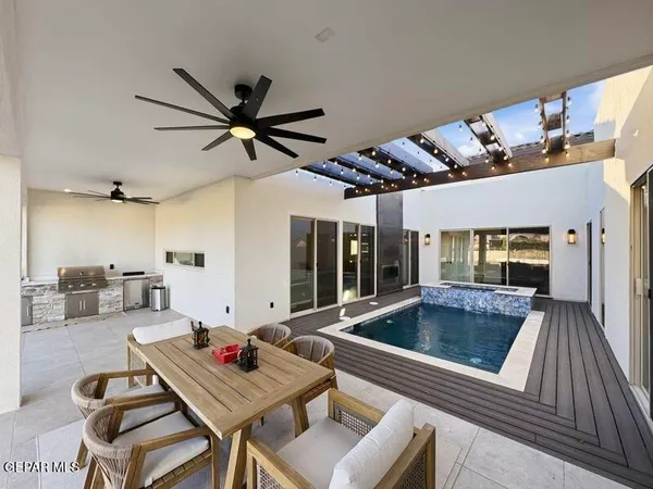 a living room with stainless steel appliances granite countertop furniture and a kitchen view