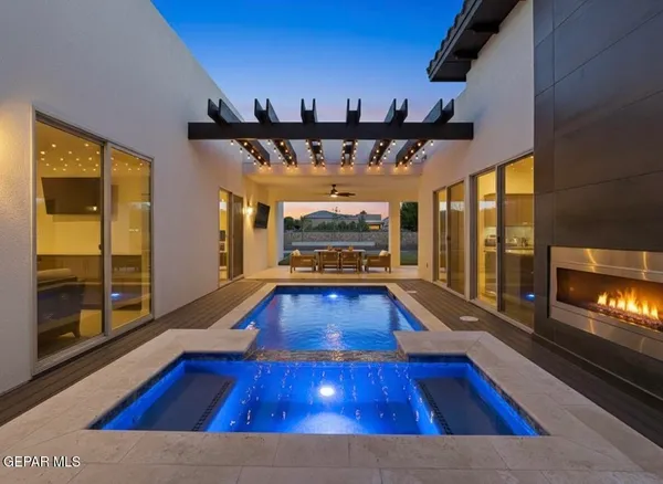 a living room with furniture pool table and a ceiling fan