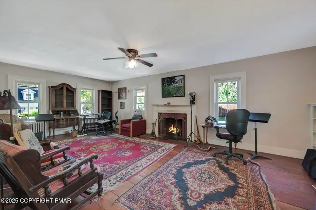 a view of a kitchen area with furniture and wooden floor