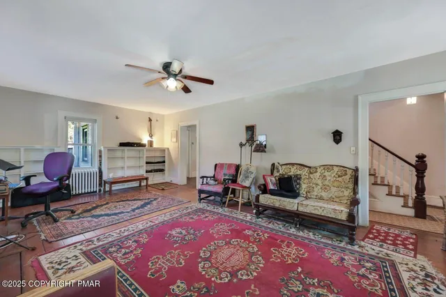 a large bedroom with a bed a dresser and flat screen tv