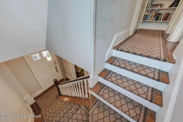 a roof deck with table and chairs with wooden floor