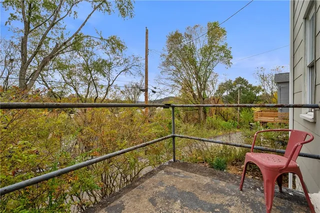 a view of a two chair and table in the balcony