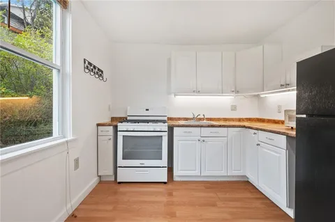 a kitchen with granite countertop a refrigerator and a stove