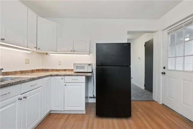 a kitchen with a refrigerator and cabinets