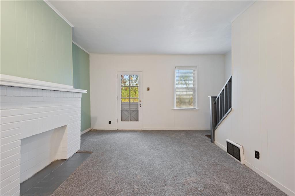 701 Maple Way Oakmont, PA 15139 - Photo 8 of 26 a view of an empty room with window and fireplace