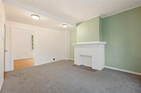 a view of an empty room with a fireplace