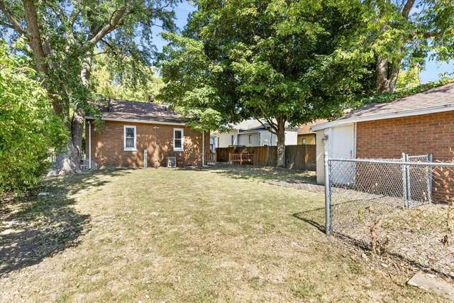 a backyard of a house with a basket ball court