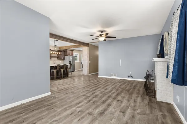 a view of a livingroom with a furniture wooden floor and a ceiling fan