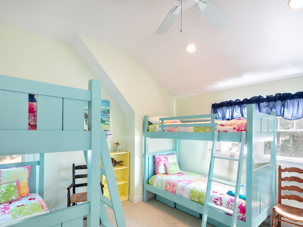 409 Monomoscoy Road Mashpee, MA 02649 - Photo 13 of 16 a bedroom with a bed and a chandelier