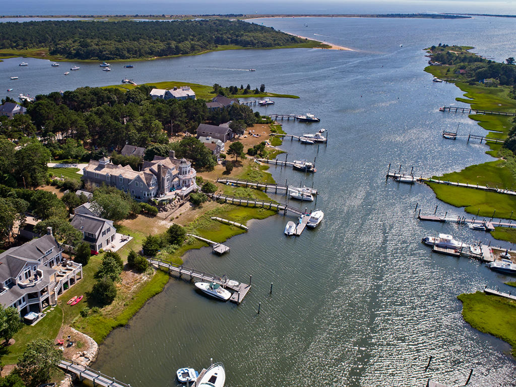 409 Monomoscoy Road Mashpee, MA 02649 - Photo 2 of 16 an aerial view of a house with a lake view