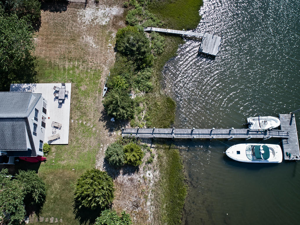409 Monomoscoy Road Mashpee, MA 02649 - Photo 3 of 16 an aerial view of a house with garden space swimming pool and outdoor seating