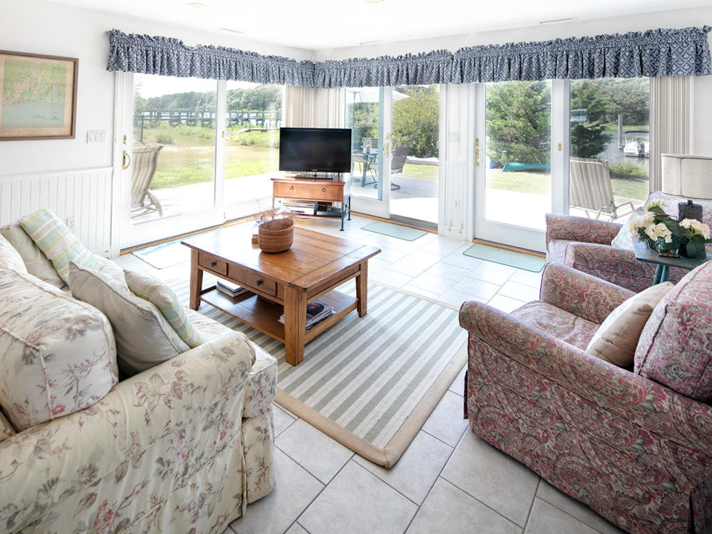 409 Monomoscoy Road Mashpee, MA 02649 - Photo 8 of 16 a living room with furniture and a flat screen tv