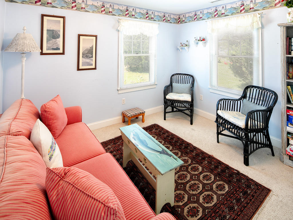409 Monomoscoy Road Mashpee, MA 02649 - Photo 10 of 16 a bedroom with furniture and a window