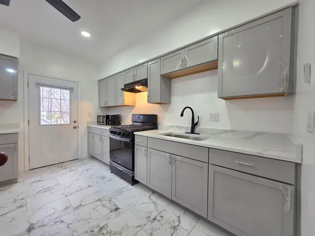a kitchen with a sink cabinets and appliances