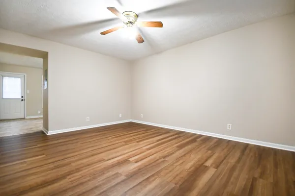 wooden floor in an empty room with a window