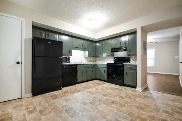 a kitchen with a refrigerator and a sink