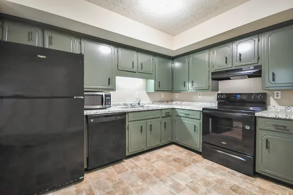 a kitchen with granite countertop stainless steel appliances and wooden cabinets