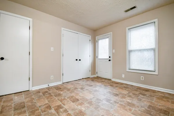 a view of an empty room with a window
