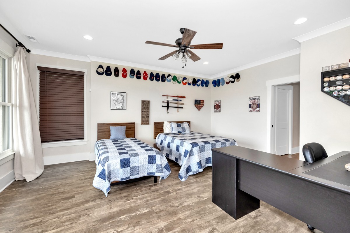 793 Davis Road Rogersville, AL 35652 - Photo 22 of 48 a bedroom with a bed and a chandelier