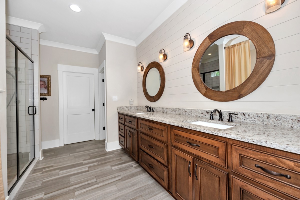 793 Davis Road Rogersville, AL 35652 - Photo 28 of 48 a bathroom with a granite countertop double vanity sink and a mirror