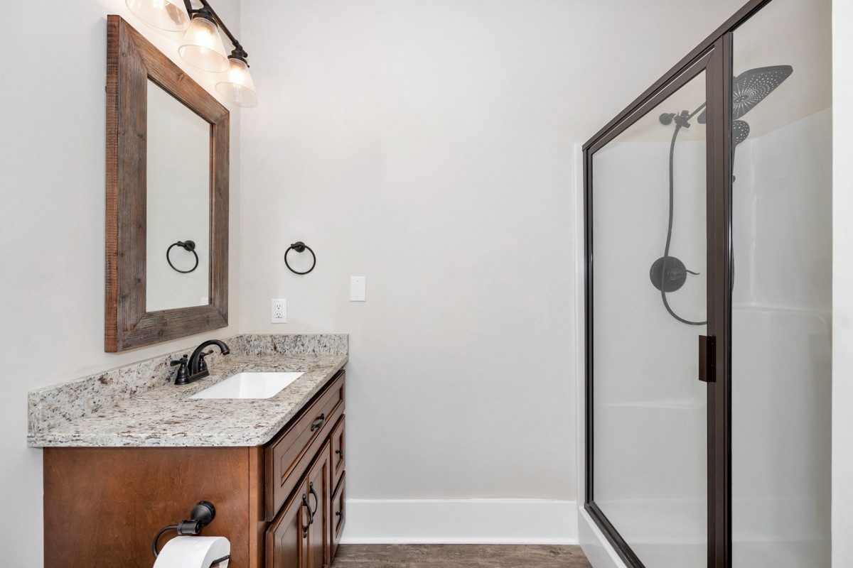 793 Davis Road Rogersville, AL 35652 - Photo 30 of 48 a bathroom with a granite countertop sink and a mirror