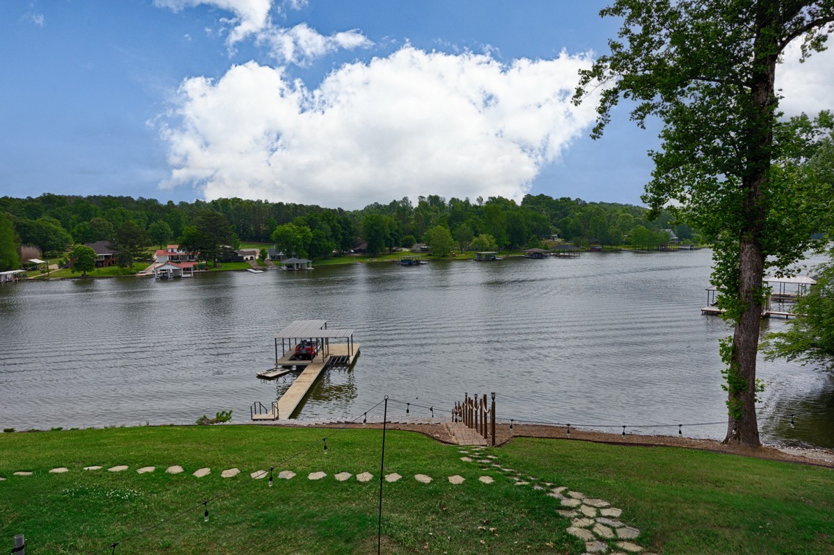 793 Davis Road Rogersville, AL 35652 - Photo 41 of 48 a view of a lake with a yard and large trees